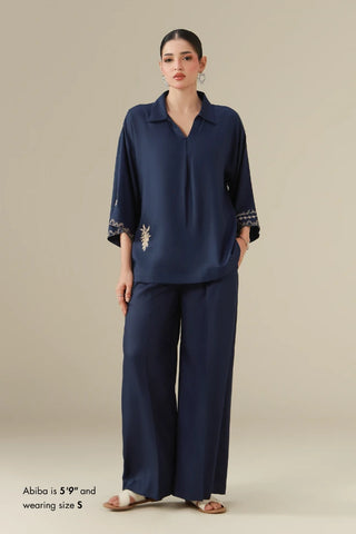 dobby crepe set featuring a short shirt, ijaar pants, and the words of Jaleel Manikpuri embroidered throughout.