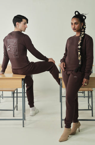 Manto's Unisex Premium Fleece Sanki Brown Sweatshirt featuring Motif with Urdu Calligraphy at the back Paired with Brown Jogger Pants